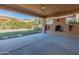 Covered patio with fireplace and view of landscaped backyard at 12750 W Jasmine Trl, Peoria, AZ 85383