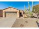 Tan house with a two-car garage and cacti in front at 12750 W Jasmine Trl, Peoria, AZ 85383