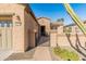 Front entry with walkway, wrought iron gate, and stone accents at 12750 W Jasmine Trl, Peoria, AZ 85383