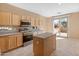 Open kitchen with island and access to patio at 12750 W Jasmine Trl, Peoria, AZ 85383