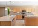 Modern kitchen featuring stainless steel appliances and light wood cabinets at 12750 W Jasmine Trl, Peoria, AZ 85383