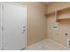 Laundry room with built-in shelving and door at 12750 W Jasmine Trl, Peoria, AZ 85383