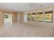 Spacious living room with tile floors, ceiling fan, and views of backyard at 12750 W Jasmine Trl, Peoria, AZ 85383