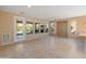Bright living room with tile floors, ceiling fan, and backyard access at 12750 W Jasmine Trl, Peoria, AZ 85383