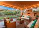 Inviting covered patio featuring a cozy fireplace, comfortable seating, and serene outdoor ambiance at 12750 W Jasmine Trl, Peoria, AZ 85383