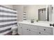 Bathroom featuring a single sink, white cabinets, and a shower-tub combination at 12937 W Highland Ave, Litchfield Park, AZ 85340