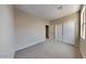 Spacious bedroom with carpet and double door closet at 12937 W Highland Ave, Litchfield Park, AZ 85340