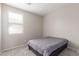 Carpeted bedroom featuring a window with blinds, and neutral walls at 12937 W Highland Ave, Litchfield Park, AZ 85340