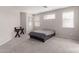 Serene bedroom with neutral walls, carpet, and natural light from the windows at 12937 W Highland Ave, Litchfield Park, AZ 85340