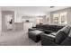 Spacious open-concept living area featuring neutral walls and a comfortable sectional sofa at 12937 W Highland Ave, Litchfield Park, AZ 85340