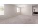 Open living space with neutral walls, carpet, and natural light from the window at 12937 W Highland Ave, Litchfield Park, AZ 85340