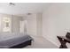 Spacious main bedroom featuring neutral carpet, an ensuite bathroom, and access to walk-in closet at 12937 W Highland Ave, Litchfield Park, AZ 85340