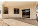 Covered patio with concrete floors, stucco walls, and sliding glass doors at 12937 W Highland Ave, Litchfield Park, AZ 85340