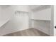 Walk-in closet featuring carpet floors, white walls, and built-in shelving at 12937 W Highland Ave, Litchfield Park, AZ 85340