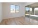 This bedroom features a large window, sliding glass door, and wood-style flooring at 1436 E Cherrywood Pl, Chandler, AZ 85249