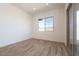 This bedroom features a large window, sliding glass door, and wood-style flooring at 1436 E Cherrywood Pl, Chandler, AZ 85249