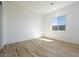 Bright bedroom featuring wood-look tile flooring and a window for natural light at 1436 E Cherrywood Pl, Chandler, AZ 85249