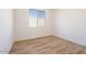 Bedroom with wood-look tile flooring and a window providing ample natural light at 1436 E Cherrywood Pl, Chandler, AZ 85249