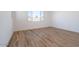 Bright bedroom featuring wood-look tile flooring and a window for natural light at 1436 E Cherrywood Pl, Chandler, AZ 85249