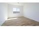 This bedroom features a bright window and wood-style flooring at 1436 E Cherrywood Pl, Chandler, AZ 85249