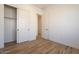 Bright bedroom featuring wood-look tile floors, white walls and trim, closet and interior doors at 1436 E Cherrywood Pl, Chandler, AZ 85249