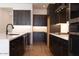 Elegant kitchen featuring dark cabinets, white counters, and modern fixtures at 1436 E Cherrywood Pl, Chandler, AZ 85249