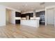 Open kitchen with dark cabinetry, large island, and stainless steel appliances at 1436 E Cherrywood Pl, Chandler, AZ 85249