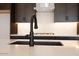 Close-up of kitchen island featuring a modern faucet and quartz countertop at 1436 E Cherrywood Pl, Chandler, AZ 85249