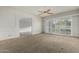 Spacious living room with neutral carpet, decorative wall panels, and large windows at 145 E Boca Raton Rd, Phoenix, AZ 85022