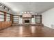 Cozy living room features a brick fireplace, hardwood floors, and custom built-in bookshelves at 145 E Boca Raton Rd, Phoenix, AZ 85022