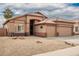 Tan two-story house with a two-car garage and desert landscaping at 15825 W Durango St, Goodyear, AZ 85338