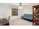 Bright bedroom with a futon, a ceiling fan and a window with natural light at 17645 E Stacey Rd, Queen Creek, AZ 85142