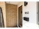 Modern entryway with a wood door and brick accents at 1850 W Stella Ln, Phoenix, AZ 85015