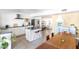 Modern kitchen with white cabinets, island, and dining area at 1850 W Stella Ln, Phoenix, AZ 85015