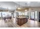 Open concept kitchen with large island and wood flooring at 19326 E Silver Creek Ln, Queen Creek, AZ 85142