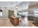 Island kitchen with green cabinets and modern lighting at 19326 E Silver Creek Ln, Queen Creek, AZ 85142