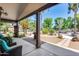 Covered patio with seating area and backyard view at 19326 E Silver Creek Ln, Queen Creek, AZ 85142