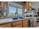 Kitchen sink and countertop with wood cabinets and tile backsplash at 197 N Pottebaum Ave, Casa Grande, AZ 85122