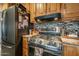 Modern kitchen with stainless steel stove and wood cabinets at 197 N Pottebaum Ave, Casa Grande, AZ 85122