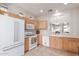 Bright kitchen featuring wood cabinets, modern appliances, and tile flooring at 21056 E Avenida Del Valle --, Queen Creek, AZ 85142
