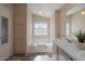 Double vanity bathroom with a soaking tub and shower at 215 N Power Rd # 440, Mesa, AZ 85205