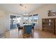 Bright dining area with wood table and four teal chairs, features a view to the backyard at 215 N Power Rd # 440, Mesa, AZ 85205