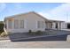 Tan single-story home with carport and landscaping at 215 N Power Rd # 440, Mesa, AZ 85205