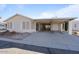 Front view of a tan house with carport at 215 N Power Rd # 440, Mesa, AZ 85205