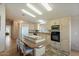 Kitchen boasts an island with cooktop, light wood cabinets, and stainless steel appliances at 215 N Power Rd # 440, Mesa, AZ 85205