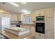 Modern kitchen with light wood cabinets, granite countertops, and stainless steel appliances at 215 N Power Rd # 440, Mesa, AZ 85205