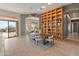 Bright dining room with a wood table and modern chairs, adjacent to a bookcase at 2207 W Camargo Dr, Anthem, AZ 85086