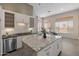 Modern kitchen with white cabinets, large island, and subway tile backsplash at 2207 W Camargo Dr, Anthem, AZ 85086