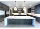 Modern kitchen with large island, dark wood cabinets, and unique marble countertop at 25007 N 89Th St, Scottsdale, AZ 85255