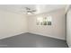 Simple bedroom with grey flooring and window with shutters at 2607 N 74Th Pl, Scottsdale, AZ 85257